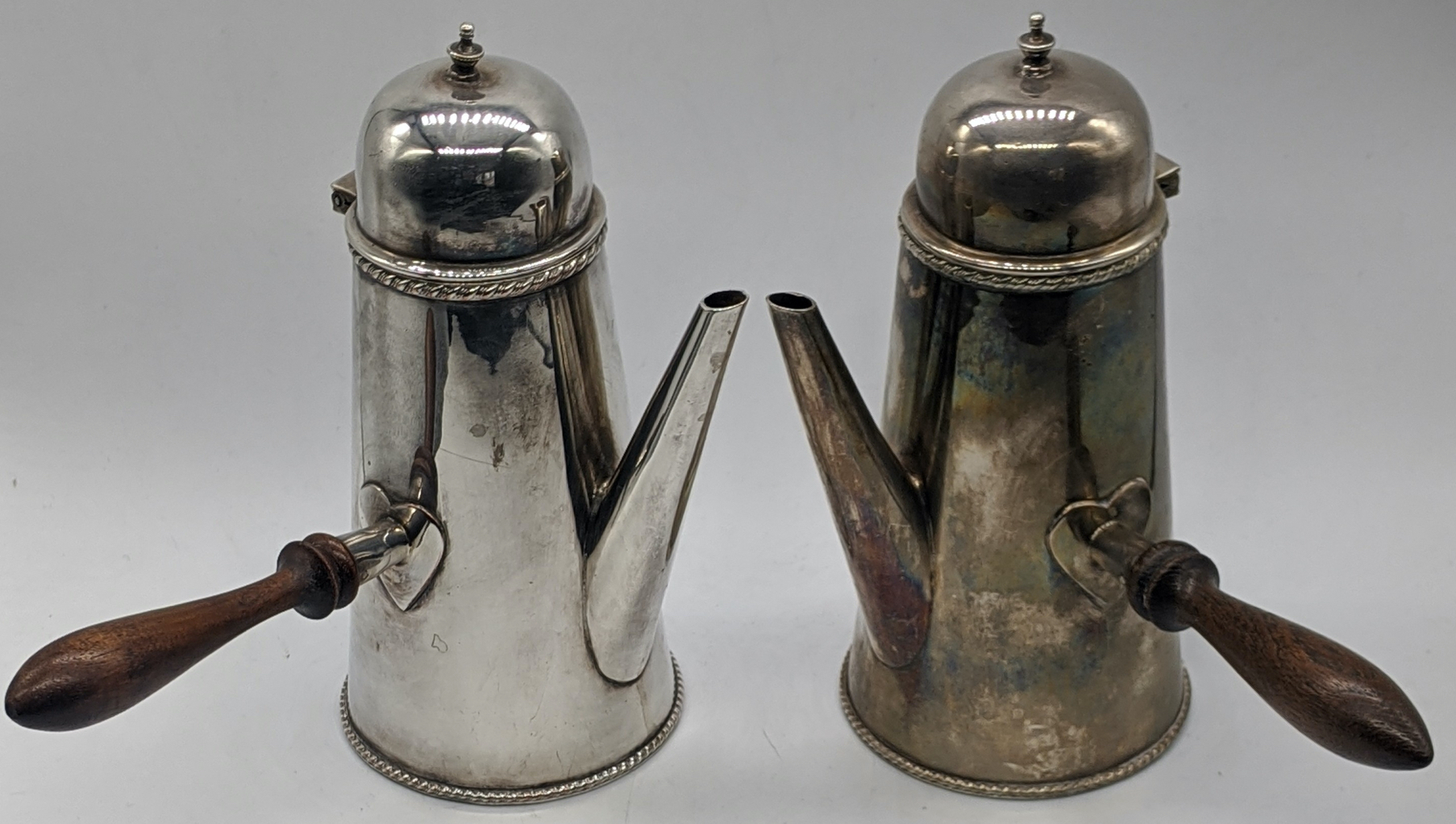 A pair of silver plated chocolate pots, wooden handles, H.17.5cm