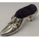 An early 20th century silver pin cushion in the form of a shoe, hallmarked Birmingham, L.11cm