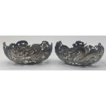 A pair of late 19th century Chinese export silver tea bowl holders by Wang Hing, pierced dragon