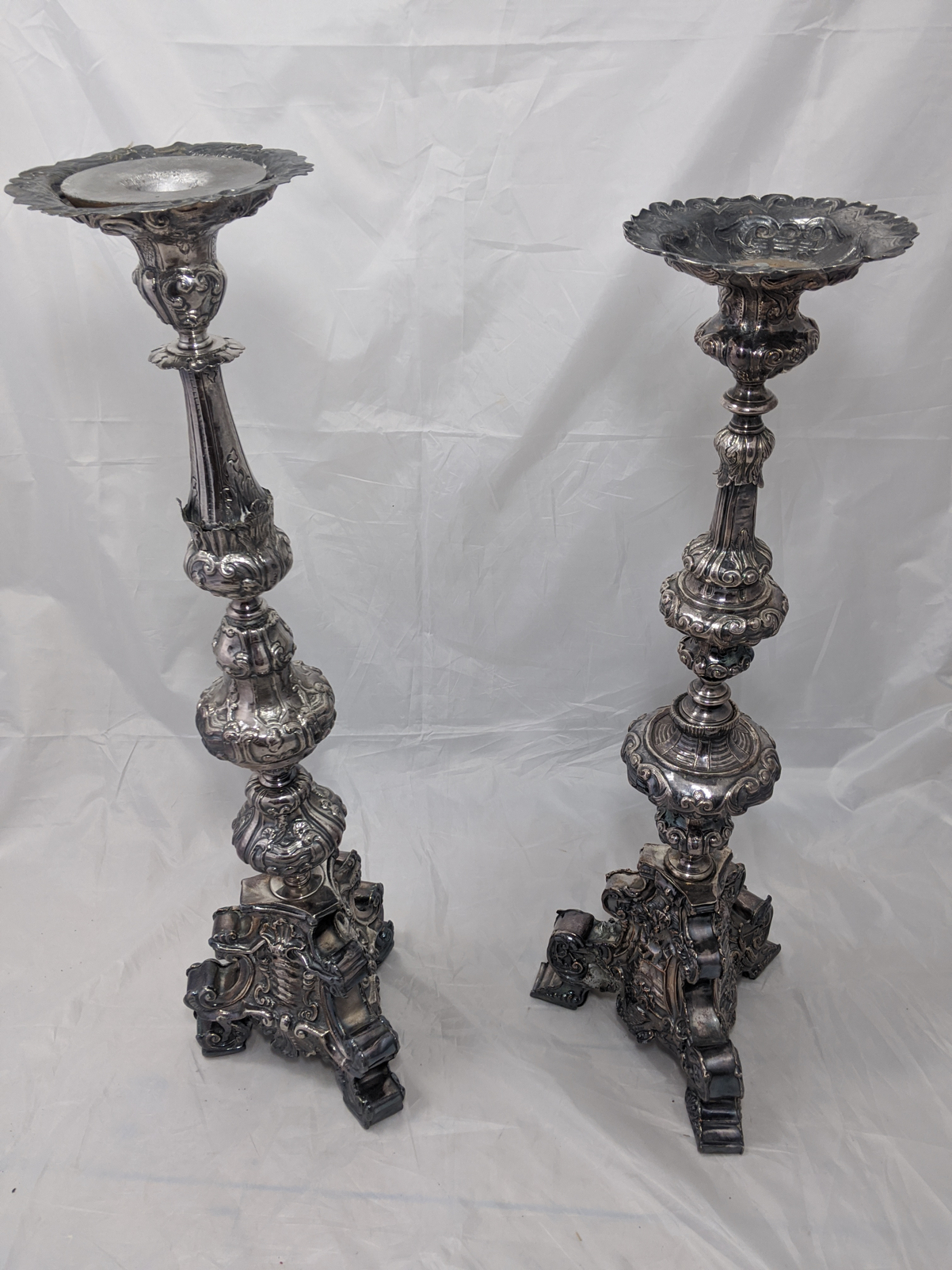 A very large and imposing pair of silver Continental pricket sticks, the stems of baluster form on