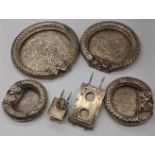 Four Islamic circular anklet dishes and a model cart, probably Oman or India