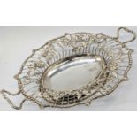 A George II silver basket by Emick Romer, twin handled with bead outer, the fretwork depicting