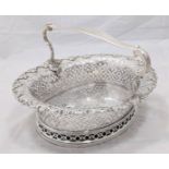 A George II silver cake basket by John Jacob, vacant scrolling shell cartouche to interior base, the