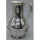 A.W.N. Pugin (1812-1852) for John Hardman & Co. a Gothic Revival silver altar jug, hallmarked
