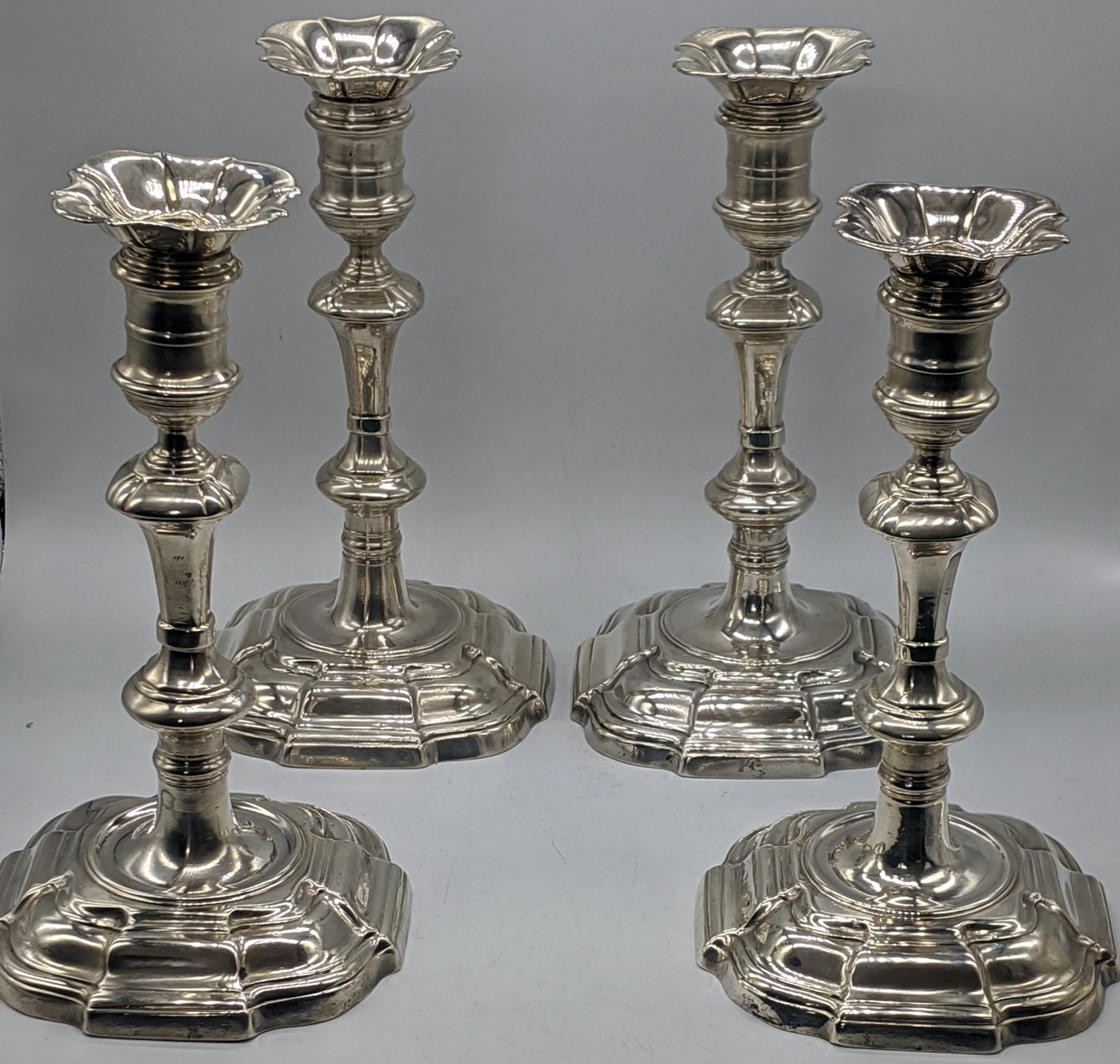 A set of four George II silver candlesticks, London 1740-50, a visible makers mark of Edward Feline,