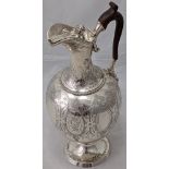 A large Victorian silver water jug by Gough & Silvester (William Gough), scrolling engraved decor,