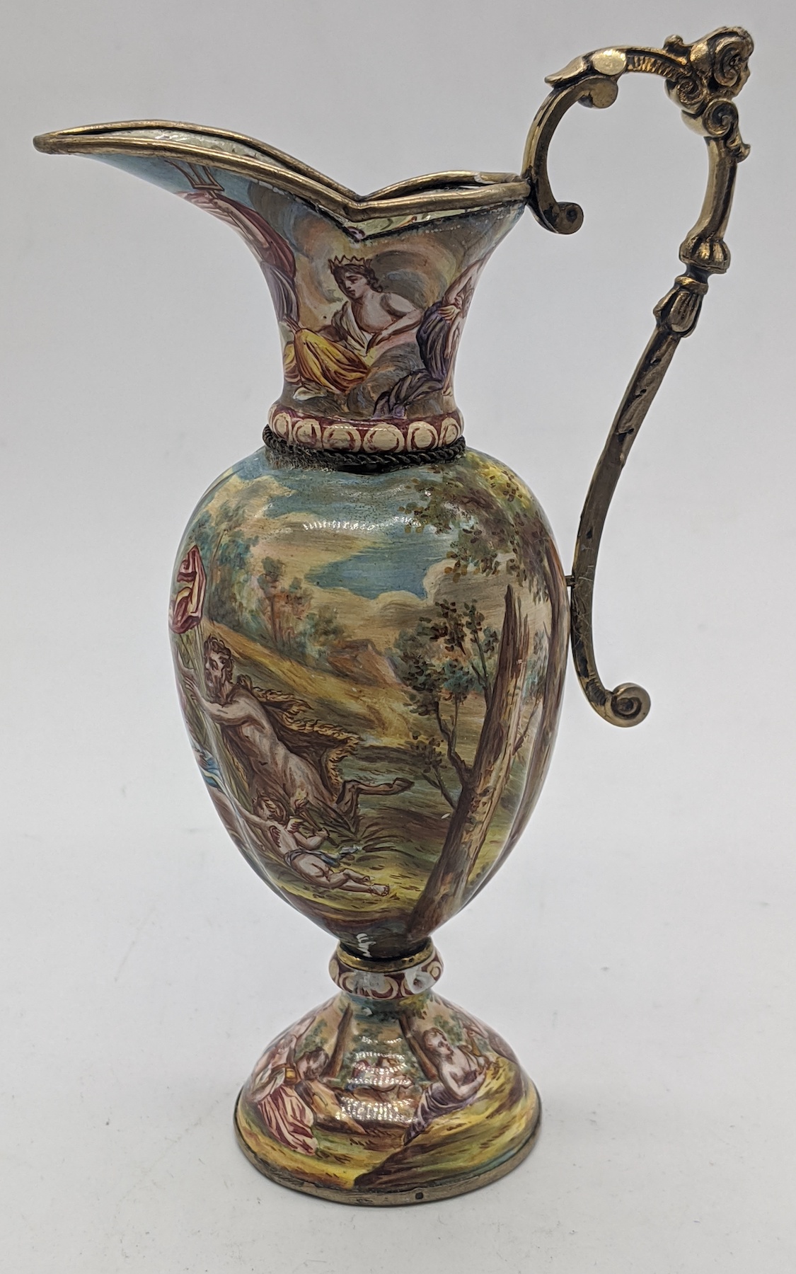 A Viennese silver and enamelled miniature jug, scenes of cherubs and gods, H.13cm