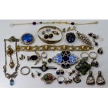 A collection of silver jewellery to include a cameo brooch, rings, bangles, earrings, Scottish