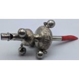 A Chinese silver rattle, coral handle, marked to handle, L.14cm
