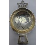 A Robert Edgar Stone silver tea strainer, crown style handle, the bowl having a planished finish,