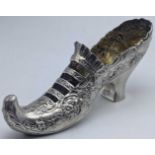 A Continental silver shoe, repousse embossed with floral designs, marks to base of heel, 102g, L.