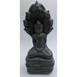 A Cambodian bronze figure of a seated Buddha in meditation, sheltered by the hood of a seven-