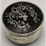 An early 20th century silver box, mounted, tortoise shell lid with inlaid silver floral decor,