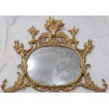 An Irish George II giltwood wall mirror, the plate surmounted by pierced fretwork and baskets of