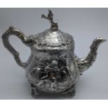 A Victorian silver Teniers teapot depicting Dutch tavern scenes in the style of David Teniers,