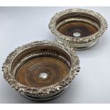 A pair of George III silver coasters, eagle crest to centre, indistinct makers mark, 568g, D.16.5cm