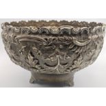 A large Continental silver bowl, repousse embossed design, raised on three feet, indistinctly marked