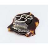 A silver musical note paper clip mounted on a tortoise shell shield, hallmarked Birmingham 1900-1,