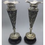 A pair of late 19th century silver Chinese export vases, pierced floral bodies, raised on hardwood