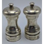 A pair of silver salt and pepper grinders, hallmarked London 1991, maker M.C.Hersey & Son Ltd, 245g,