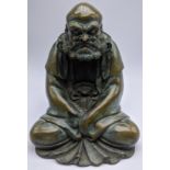 A Japanese hollow bronze study of a seated Buddha, character marks to base, H.20cm