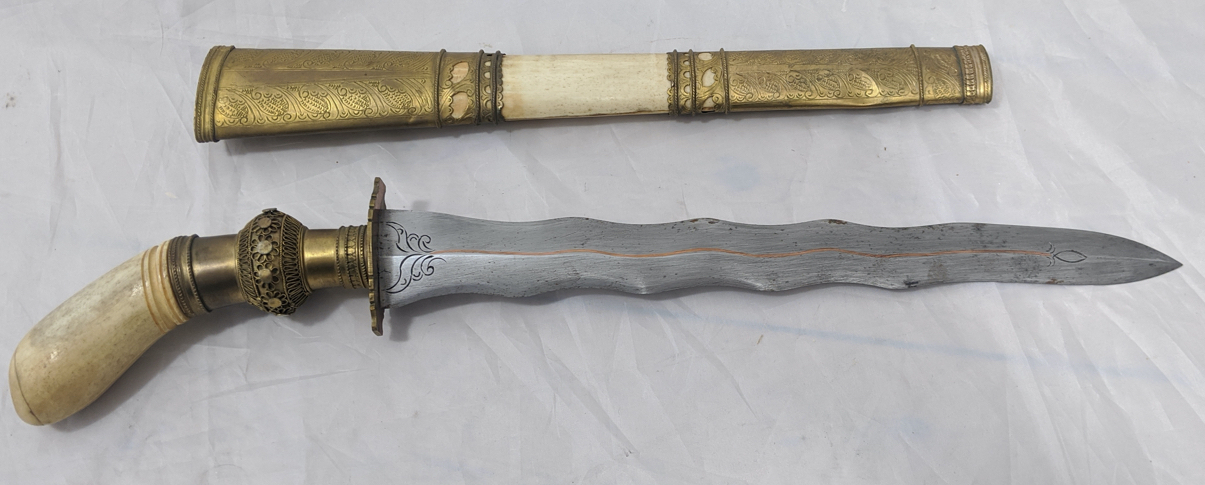 A Islamic Punal sword, carved bone handle with brass mounts, Philippines, L.50cm