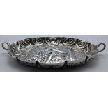 A Victorian silver twin handled dish, repousse embossed depicting a king on the throne, hallmarked