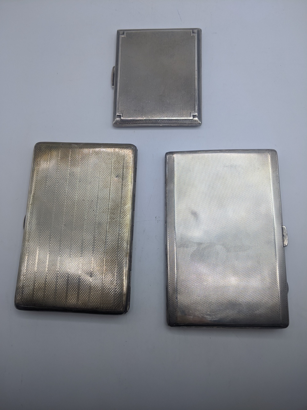 Three early 20th century Deco silver cigarette cases, engine turned outers, gilt interiors, - Image 2 of 5