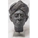 A painted terracotta bust of a Berber, indistinctly initialled, mounted on metal stand, H.33cm