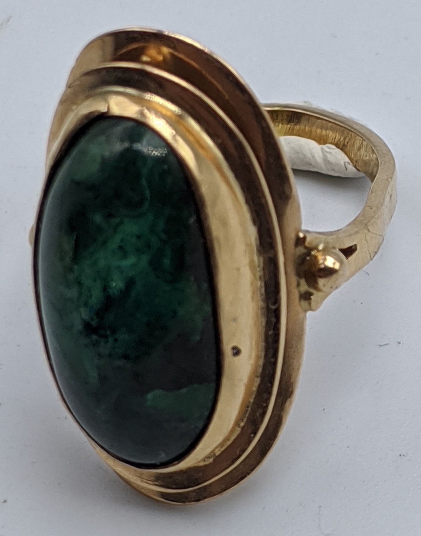 A yellow gold ring mounted with malachite stone, indistinct marks to band, 3.5g, size I,