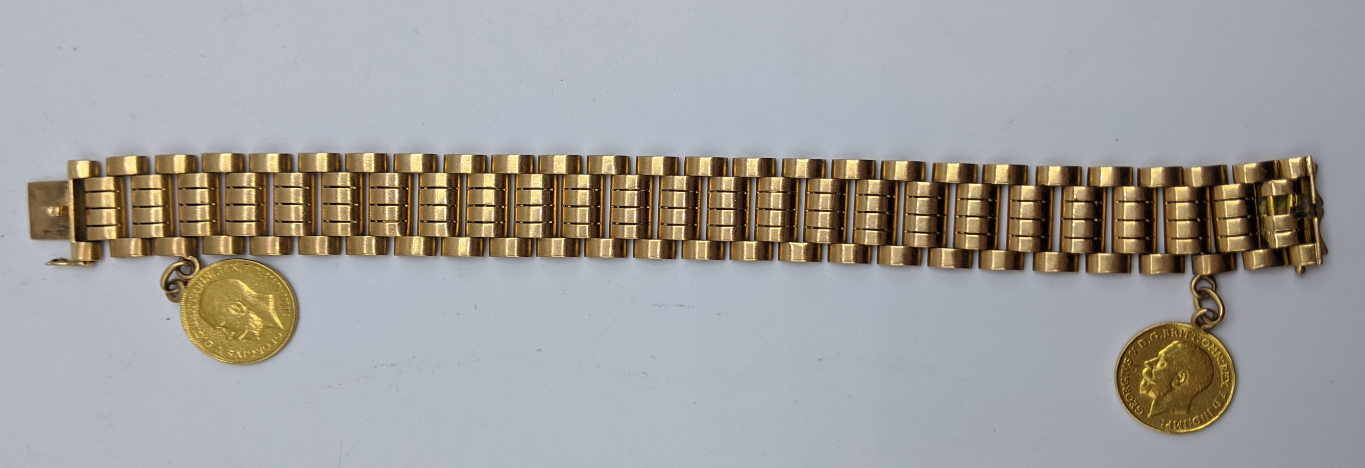 An 18ct yellow gold bracelet mounted with two half sovereigns, 53g, L.20cm W.1.5cm