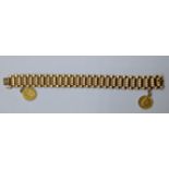 An 18ct yellow gold bracelet mounted with two half sovereigns, 53g, L.20cm W.1.5cm