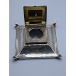 An Edwardian silver inkwell with a concealed stamp compartment to lid, gilt interior, glass liner,