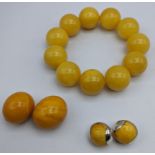 An amber bead bracelet (51g), together with two amber beads (13g) and a pair of amber earrings