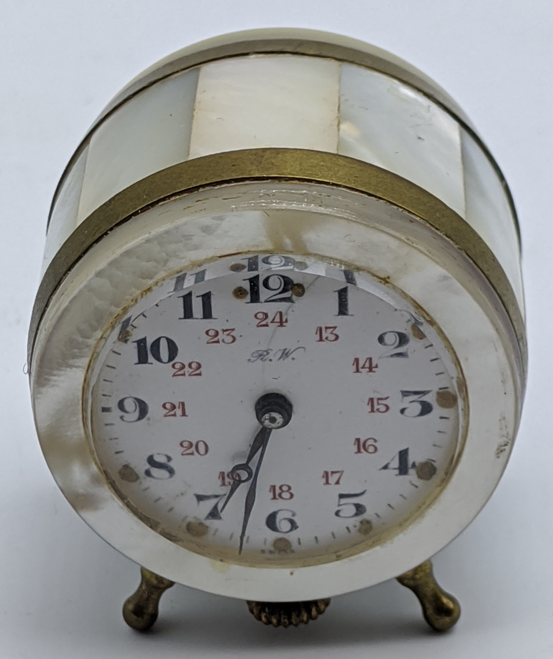 A late 19th century mother of pearl clock miniature travel clock, the face marked R.W., H.4cm
