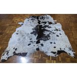 A large cow skin rug, 200cm x 200cm