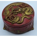 A Chinese late 19th/early 20th century red metal box depicting a dragon and flora and fauna to the