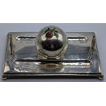 A silver inkwell in the form of a cricket ball and wickets, the ball mounted with an enamel red rose