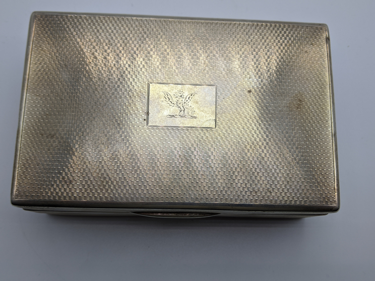 An early 20th century silver cigar case, engine turned outer, dragon crest, hallmarked London 1926- - Image 2 of 3