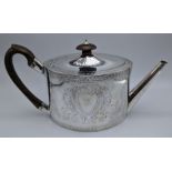 A George III silver teapot, scrolling floral and foliate decor, vacant cartouche to both sides,