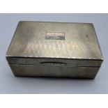 An early 20th century silver cigar case, engine turned outer, dragon crest, hallmarked London 1926-