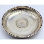 A Turkish silver dish with central silver coin, marked to inside, etched outer band, 64g, D.13cm