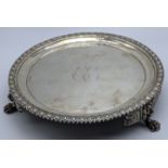 A George III silver salver, raised on three paw feet with lion head mounts, monogrammed,