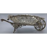 A early 20th century silver wheelbarrow, pierced fretwork depicting swallows, rotating wheel,