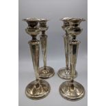 A set of 4 sterling silver candlesticks, 980g (weighted bases) H.23cm