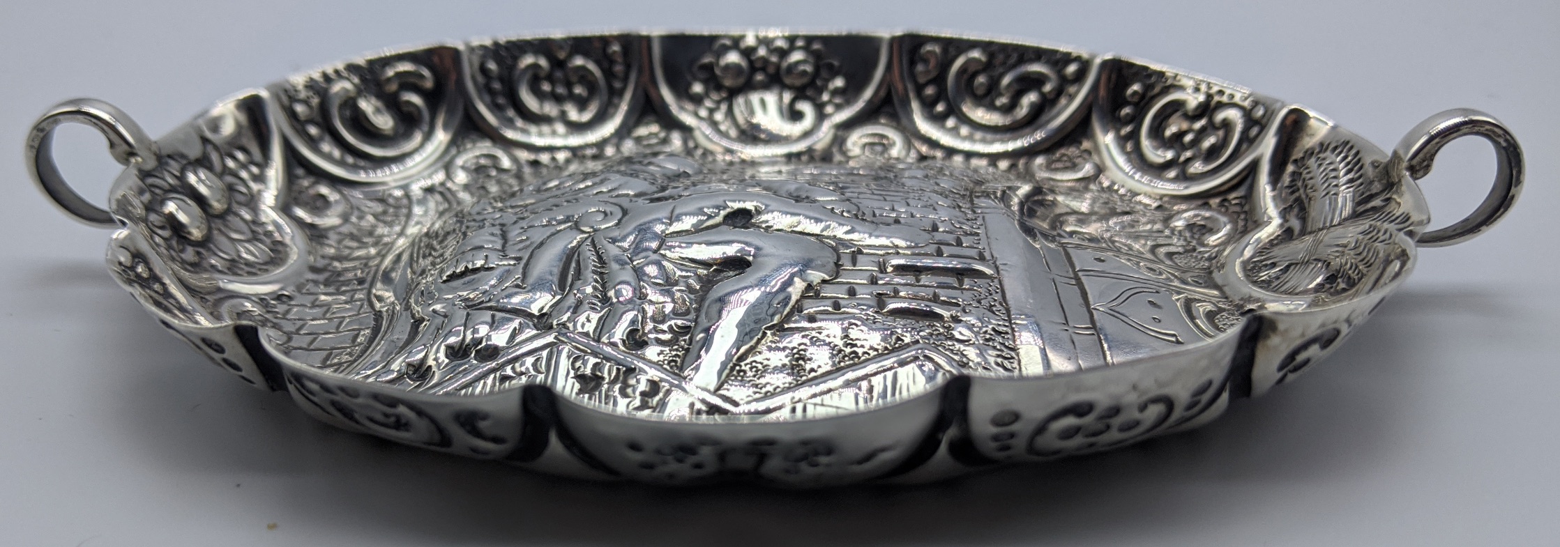 A Victorian silver twin handled wine taster, repousse embossed depicting a king on the throne, hall - Image 4 of 4