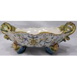 An Italian Maiolica Cantagalli style jardiniere, serpent handles, raised on 4 cherub styled feet,