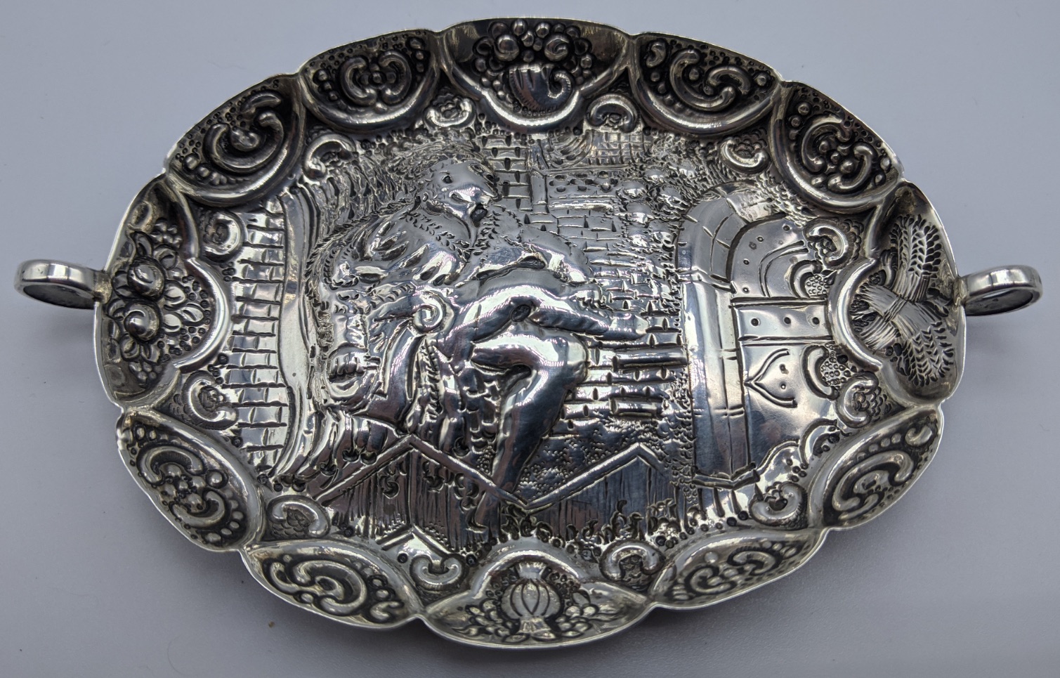 A Victorian silver twin handled wine taster, repousse embossed depicting a king on the throne, hall - Image 2 of 4