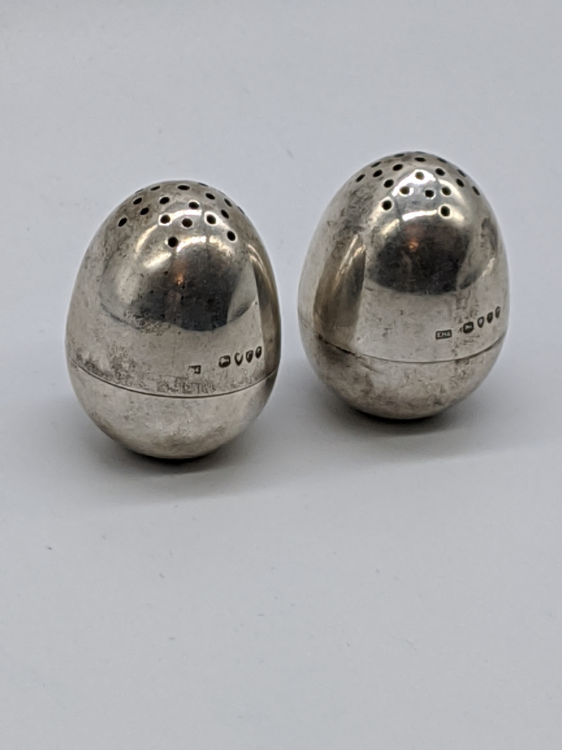 A pair of Victorian silver peppers, hallmarked London, 1878-79 to upper and lower section, maker