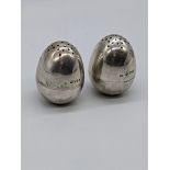 A pair of Victorian silver peppers, hallmarked London, 1878-79 to upper and lower section, maker